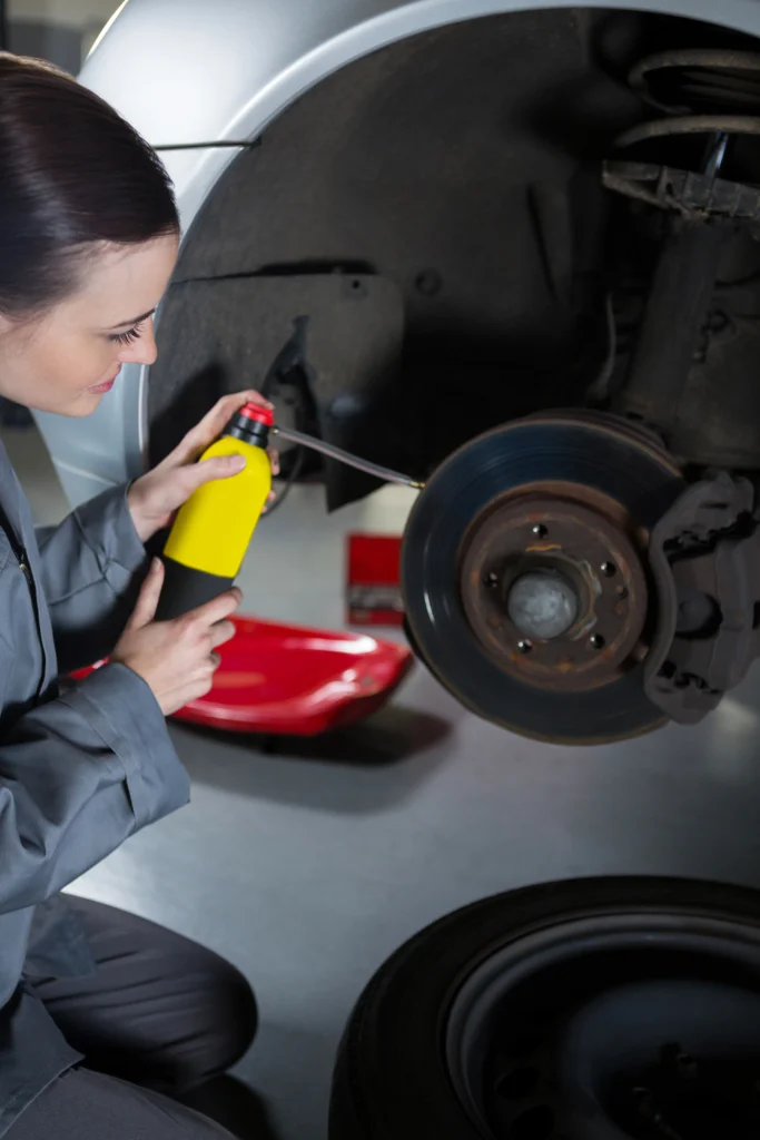 mechanic-applying-car-with-brake-fluid